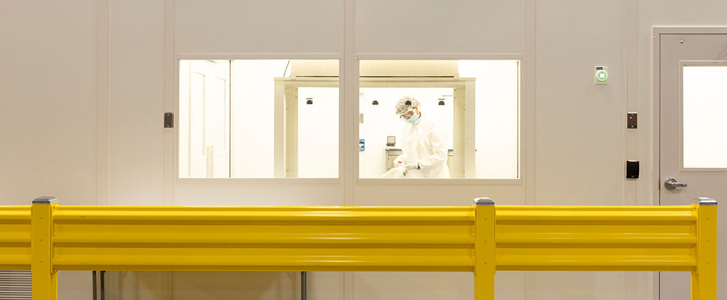 Worker inside Grade D Gowning Room Before Entering Grade C Compliant Cleanroom