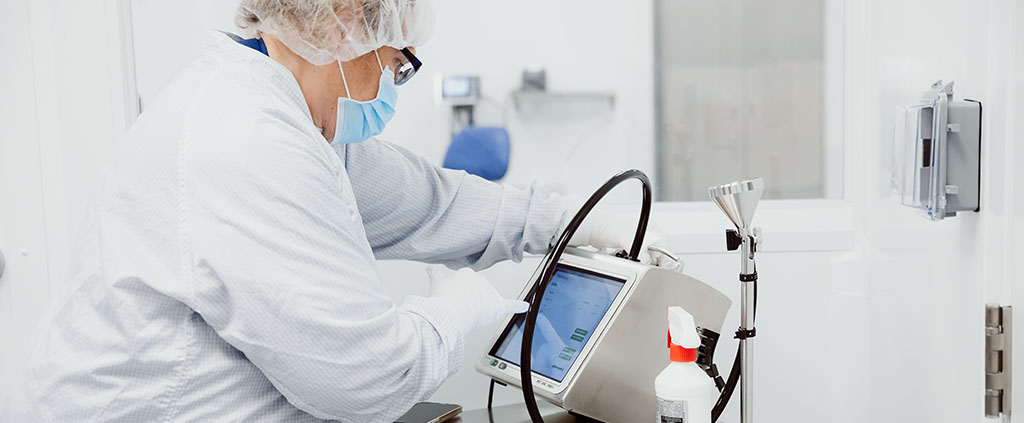 Worker in Protective Gown inside Grade C and Grade D Sampling and Dispensing Room