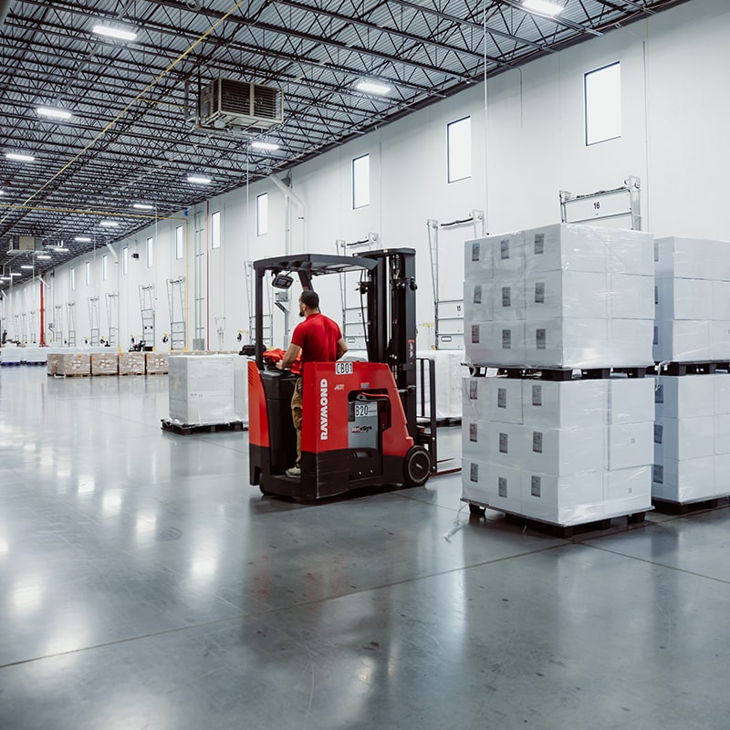 Worker Moving Boxes of Pharmaceutical Supplies and Medical Devices in the Warehouse