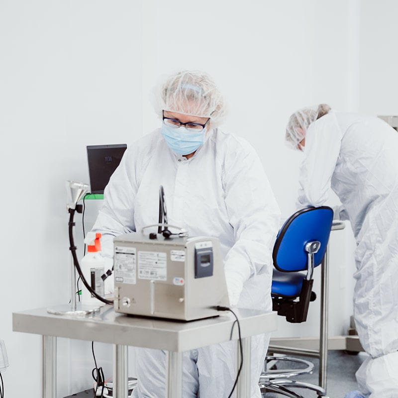 Workers in Protective Gown Operating Instruments inside Grade C Cleaning Room