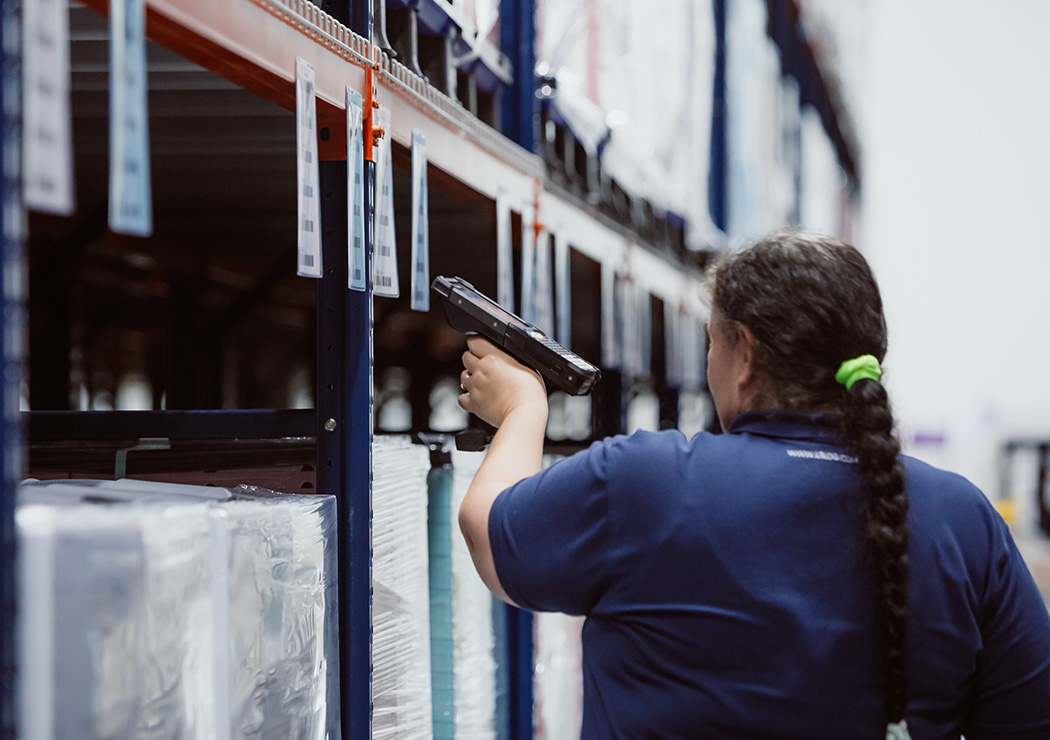 Staff Handling Inventory Inside Warehouse for Secure and Precise Distribution