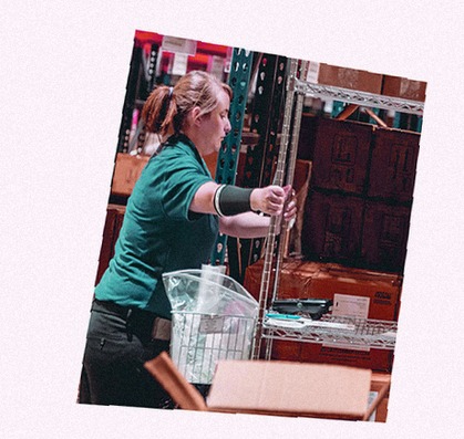 Female MMI Health Storage Worker Pushing a Cart inside Facility