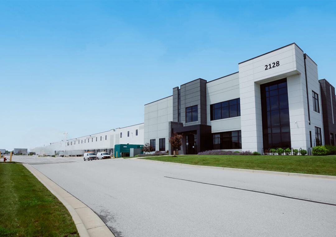 Exterior Shot of MMI Warehouse Building with Big Storage Truck on the Road