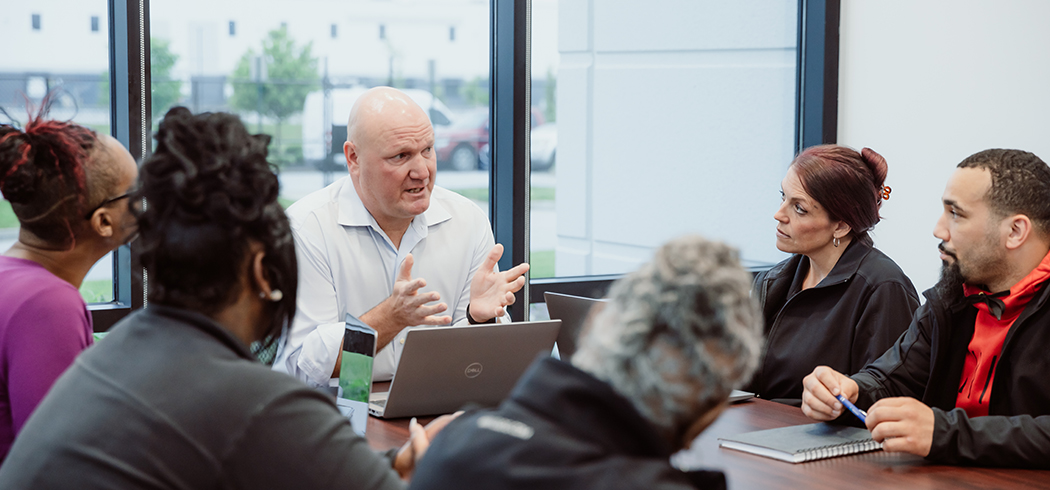 MMI Leader Speaking on Health and Patient Team Safety with Team During Meeting